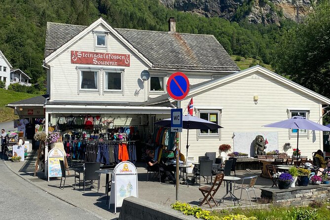 Guided tour to Hardanger Fjord, Waterfalls and Ferry Crossing - Utne offers old wooden houses and fjord views
