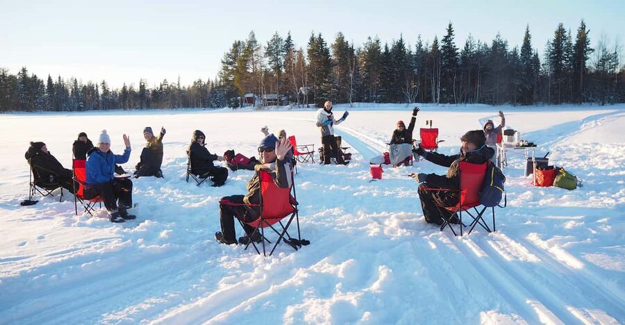 Ice fishing program in Lapland - Birchwood fire, blankets, and food