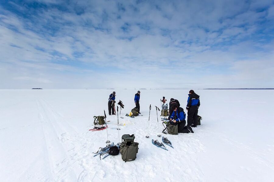 Lapland: Ice Fishing, Floating & BBQ Snow Adventure - A hot salmon lunch in a kota