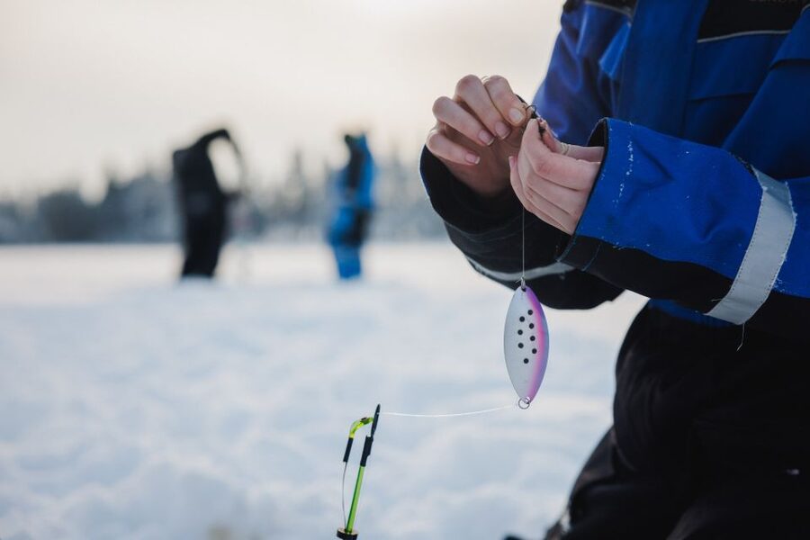 Rovaniemi: Ice Fishing & Snowmobile Safari Combo Day - Drilling a Hole in the Frozen Lake