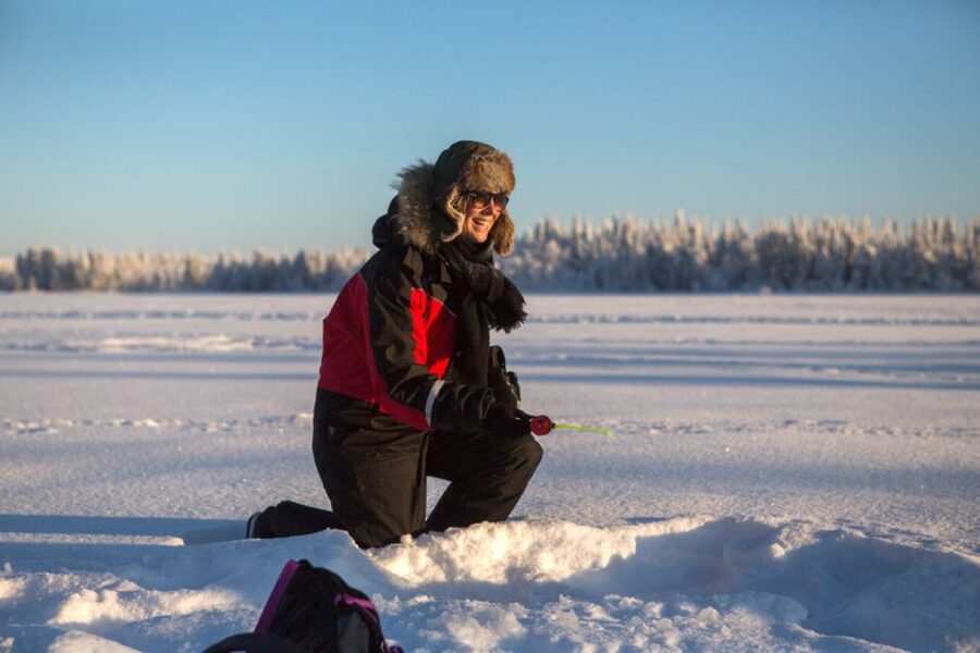 Ruka: Ice fishing trip - Warming up beside the open fire
