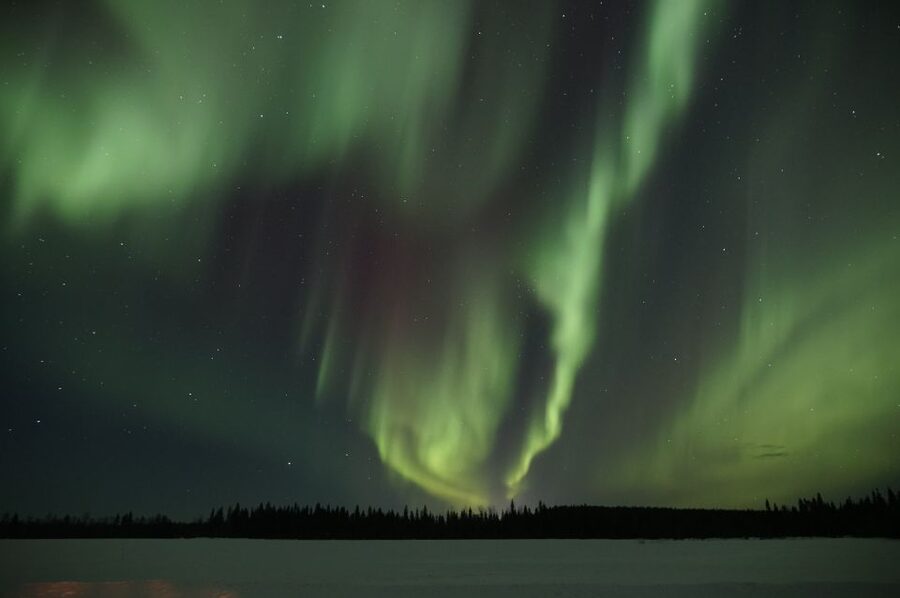 Saariselkä: Evening Snowmobile Tour with Fire & picnic - Nightfall in Saariselkä, with a snowmobile under you