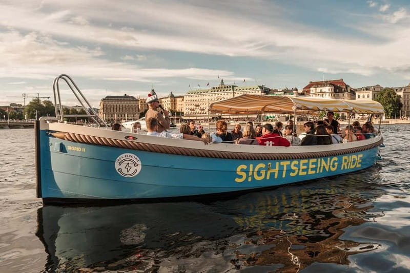 Stockholm: Guided City Sightseeing Open Electric Boat Tour - Meeting the blue boat beside Stockholm Palace
